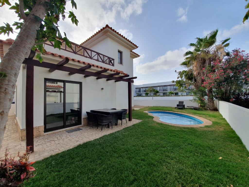PrainhaVilla with privat pool near beach Santa Maria Sal Kap Verde的一个带游泳池和房子的后院