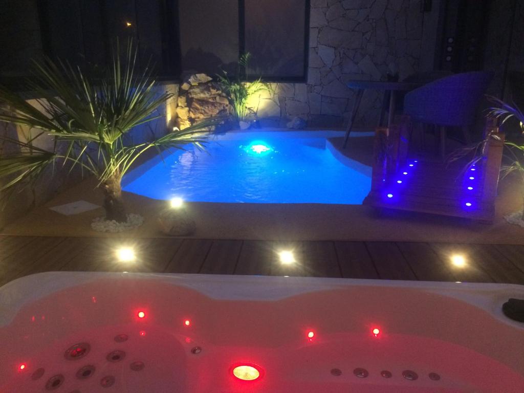 尼斯B&B Villa sensorielle的游泳池前的浴缸配有灯光