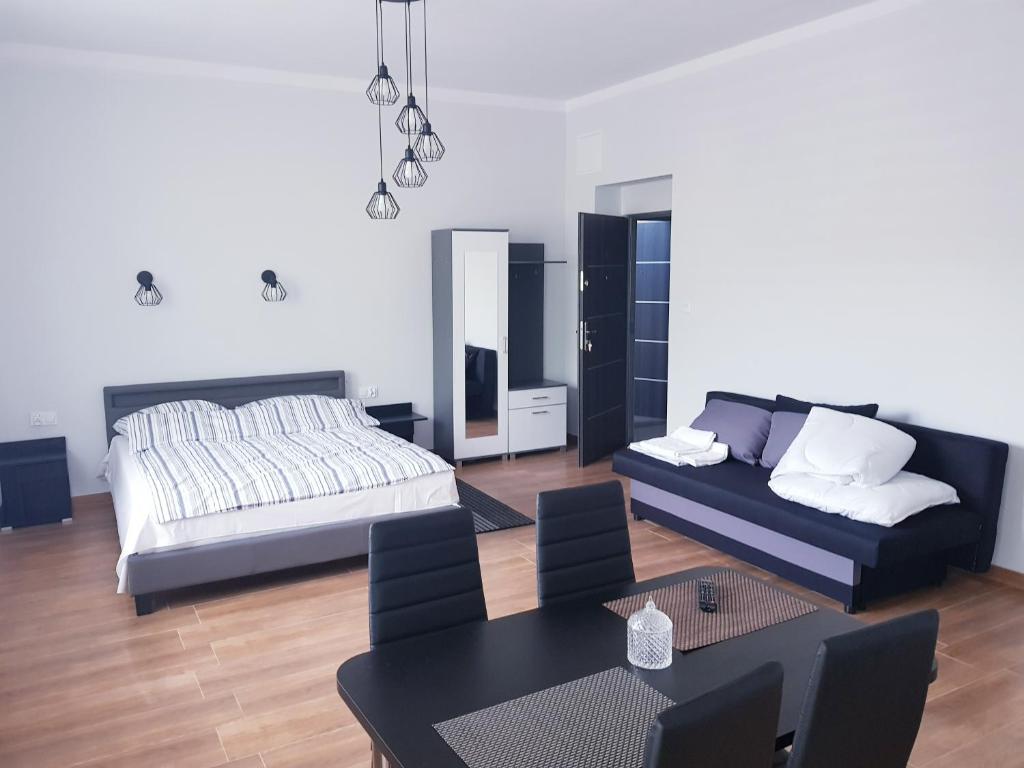 奥斯特罗维茨Apartamenty Polna的客厅配有床和桌子