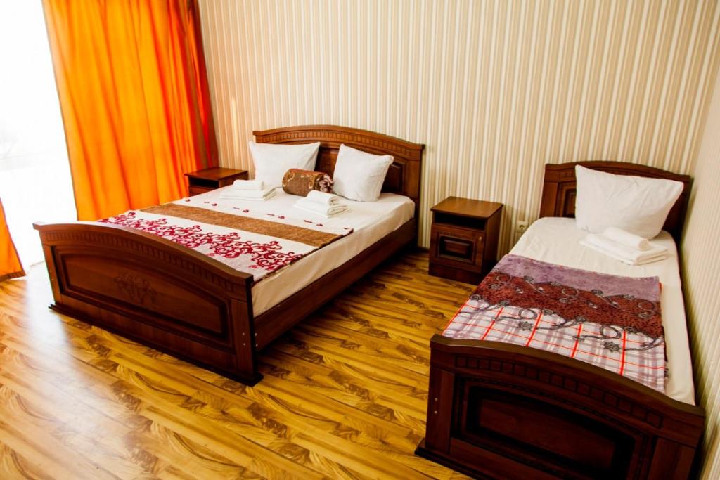 Отель Райский Уголок в Абхазии客房内的一张或多张床位