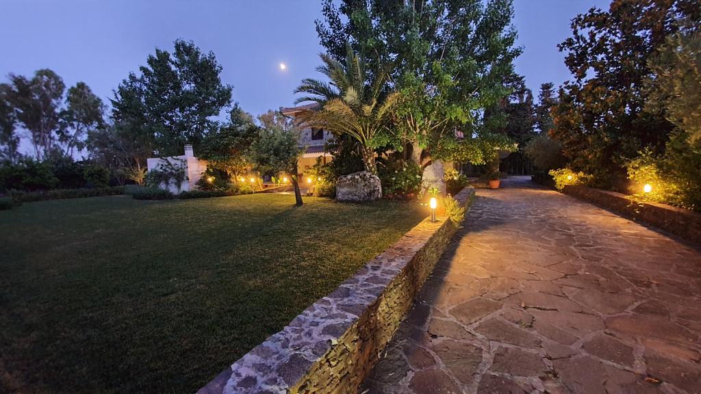阿尔盖罗Villa Canu的夜晚在草地上灯光 ⁇ 的花园