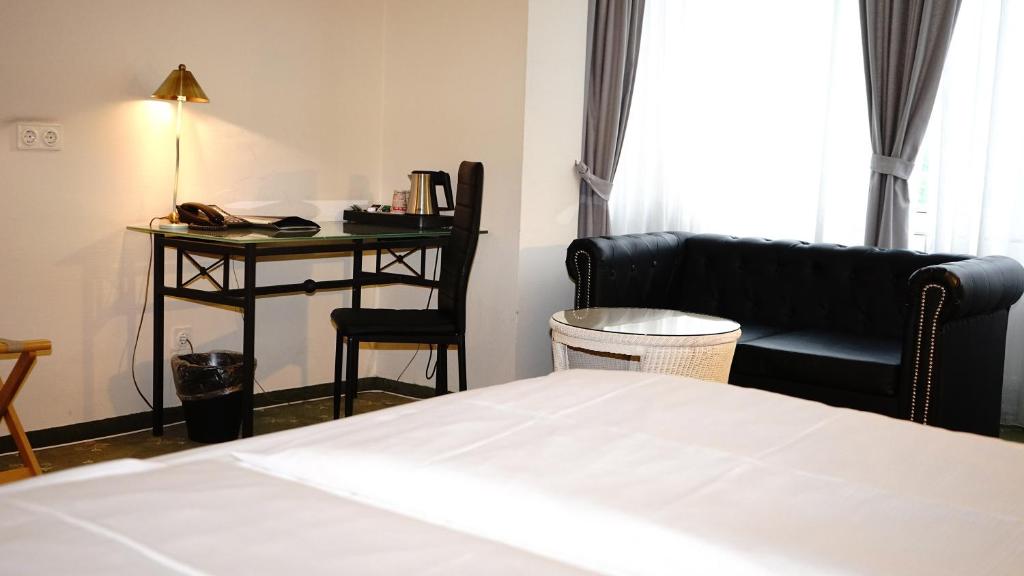大博斯特尔区加尼入口酒店客房内的一张或多张床位