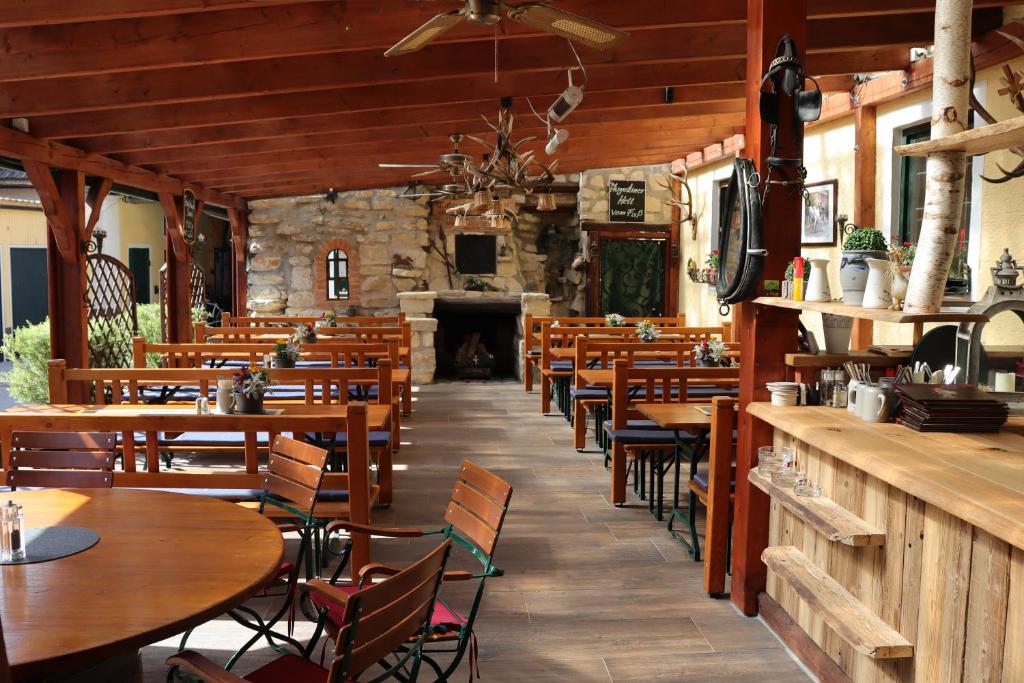 MarxheimLandsteakhaus的餐厅设有木桌、椅子和壁炉