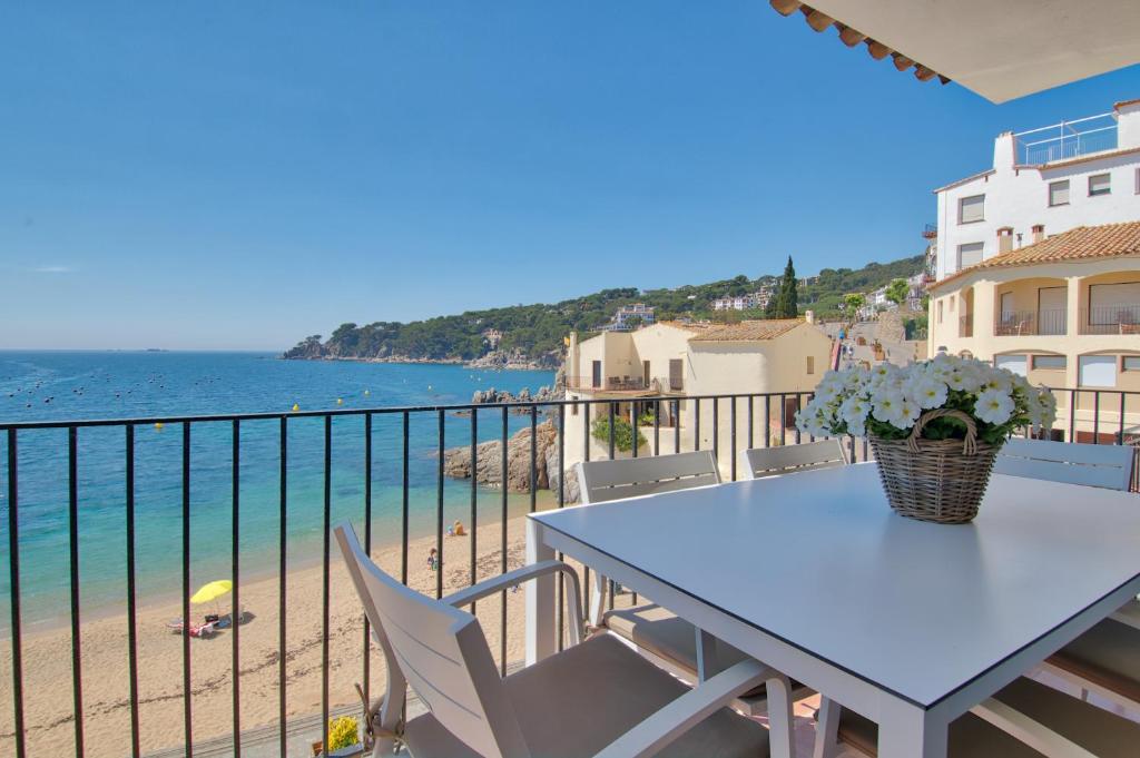 卡莱利亚德帕拉弗鲁赫尔Exclusive Position Front Line Apartments Calau的海滩景阳台桌子