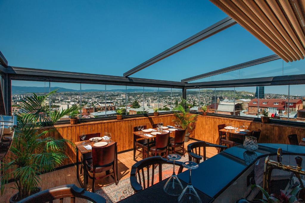 第比利斯都市精品酒店的阳台餐厅,配有桌椅