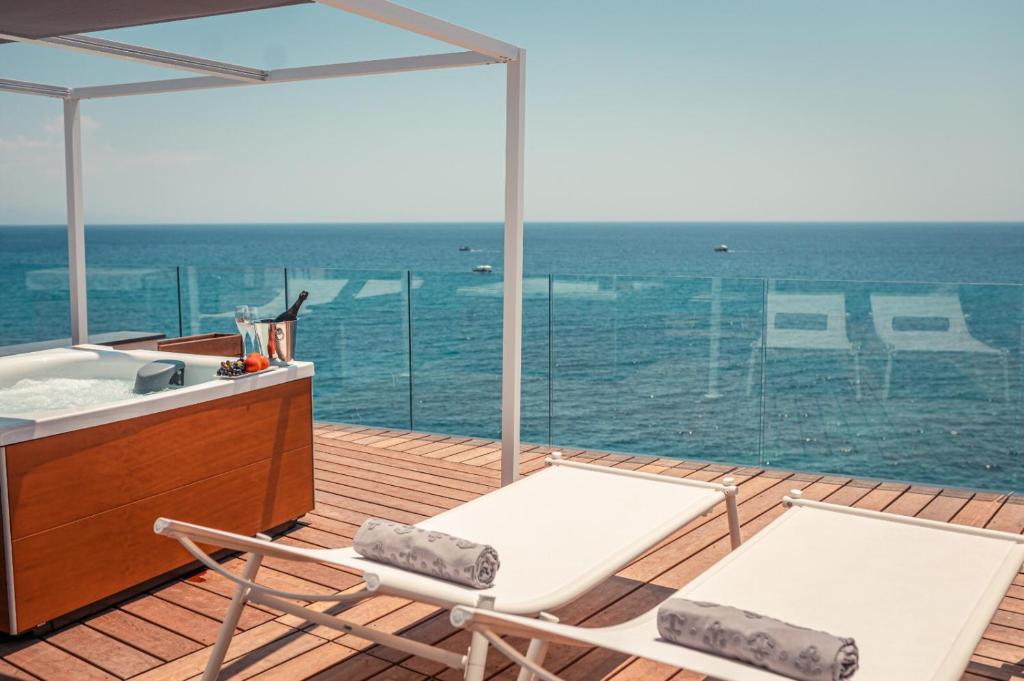贾迪尼-纳克索斯Nautilus Hotel的海景甲板上设有两把椅子和一个水槽