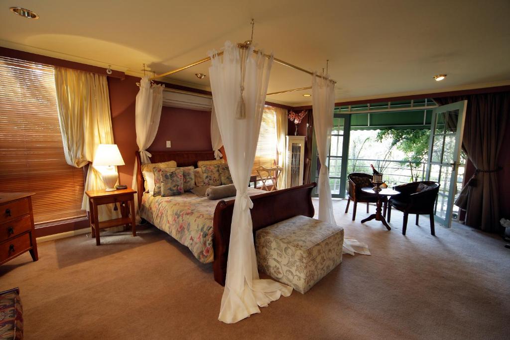 卡尔斯海滨别墅城堡的一间卧室配有天蓬床和桌椅