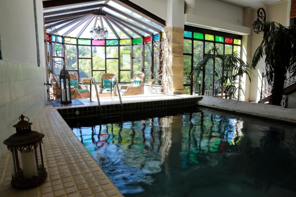奥朗日尚布尔 d'HôtesJustin de Provence酒店的一座带彩色玻璃窗的别墅内的游泳池