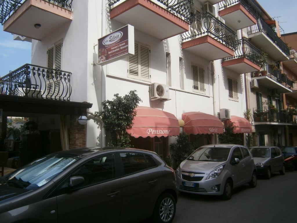 富尔奇西库洛S.安东尼奥西尔维娅餐厅旅馆的两辆汽车停在大楼前