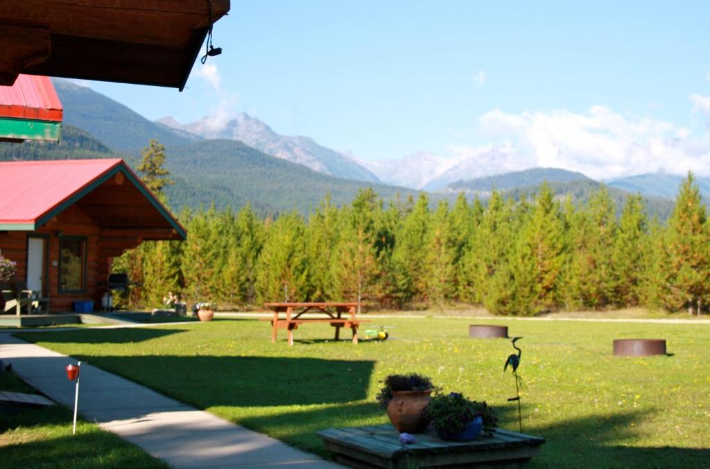 维勒蒙特双峰度假酒店的庭院内有野餐桌和山峰