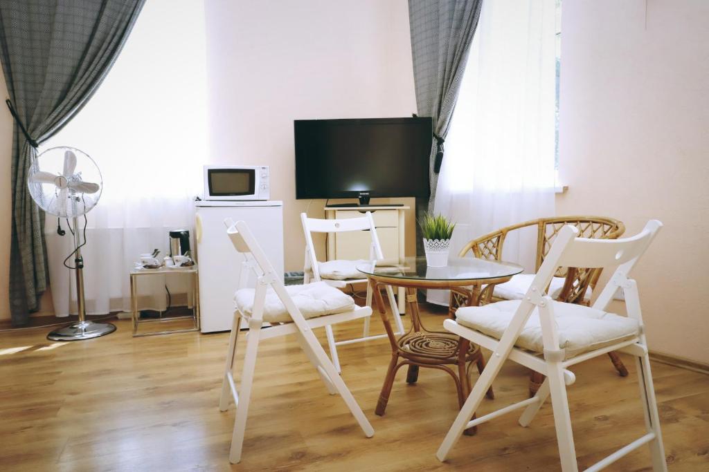 陶格夫匹尔斯Apartamenti DVINSKA的客厅配有桌椅和电视。