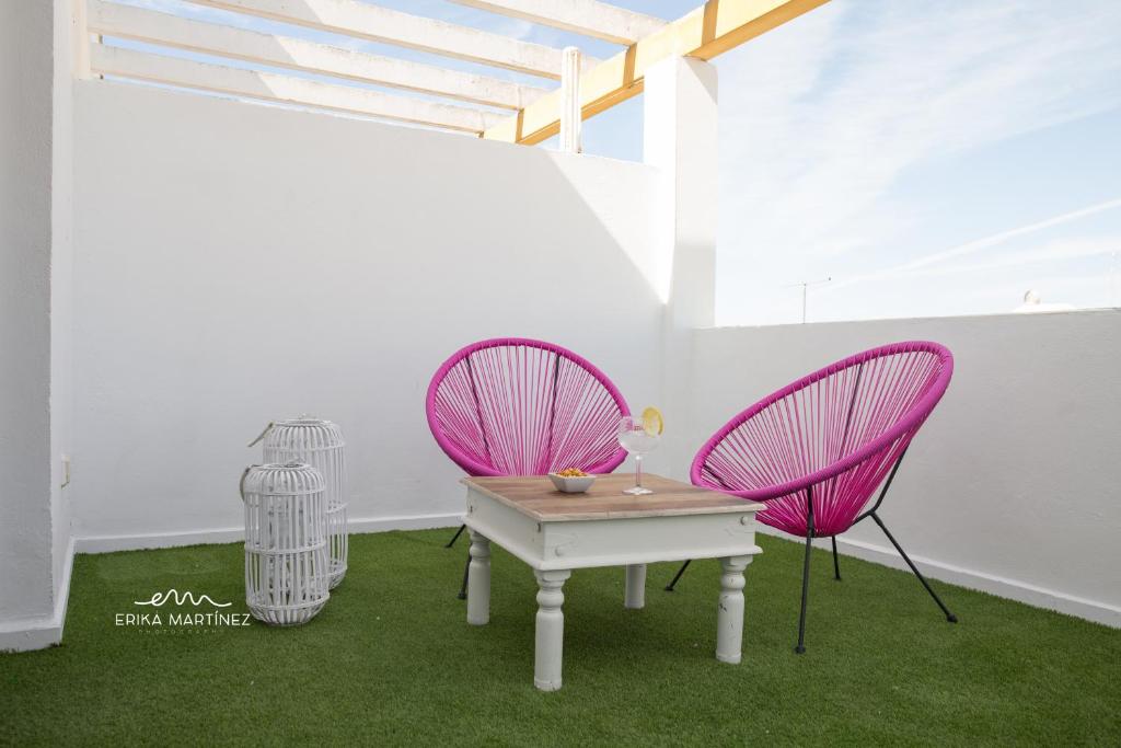 巴尔巴特MRZ Rentals Barbate La Fábrica的客房内的2把粉红色椅子和1张桌子