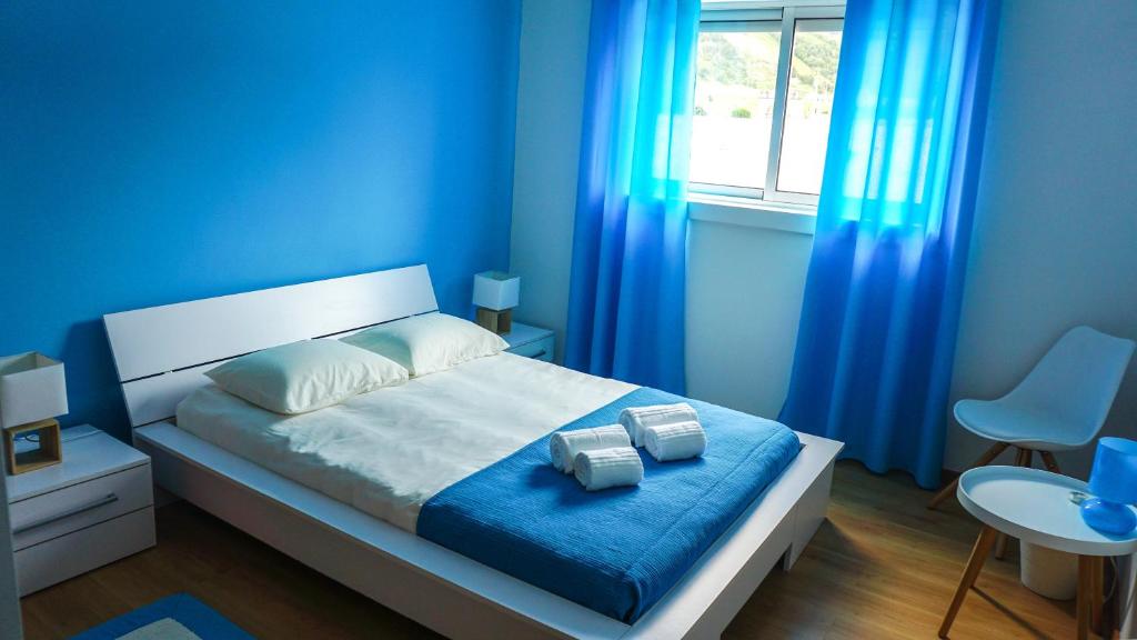 坎普自由鎮Vila Relvão的蓝色卧室,配有蓝色窗帘