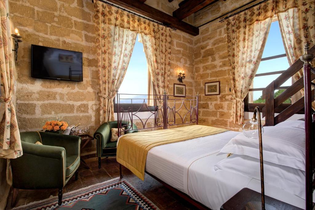 Hotel Baglio Oneto dei Principi di San Lorenzo - Luxury Wine Resort客房内的一张或多张床位