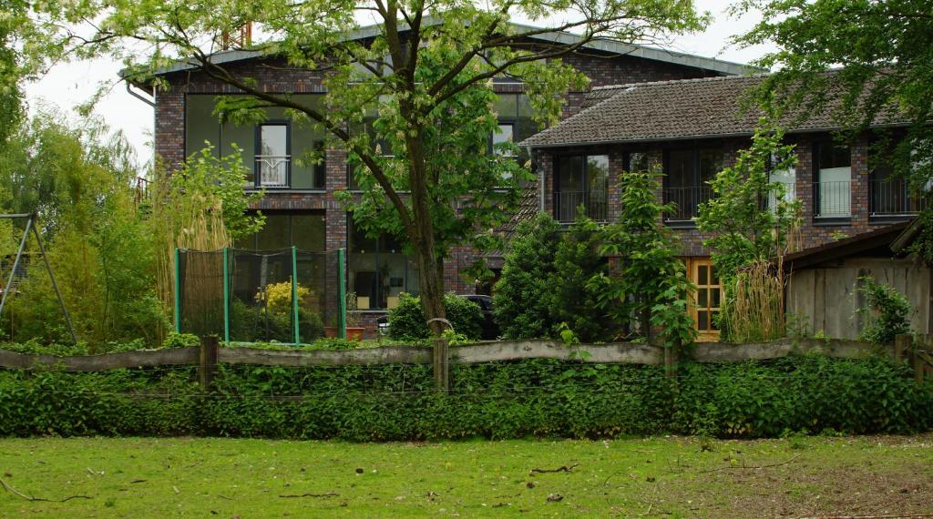 瓦伦多夫Gästewohnung Hardinghaus am Teich的院子前有围栏的房子