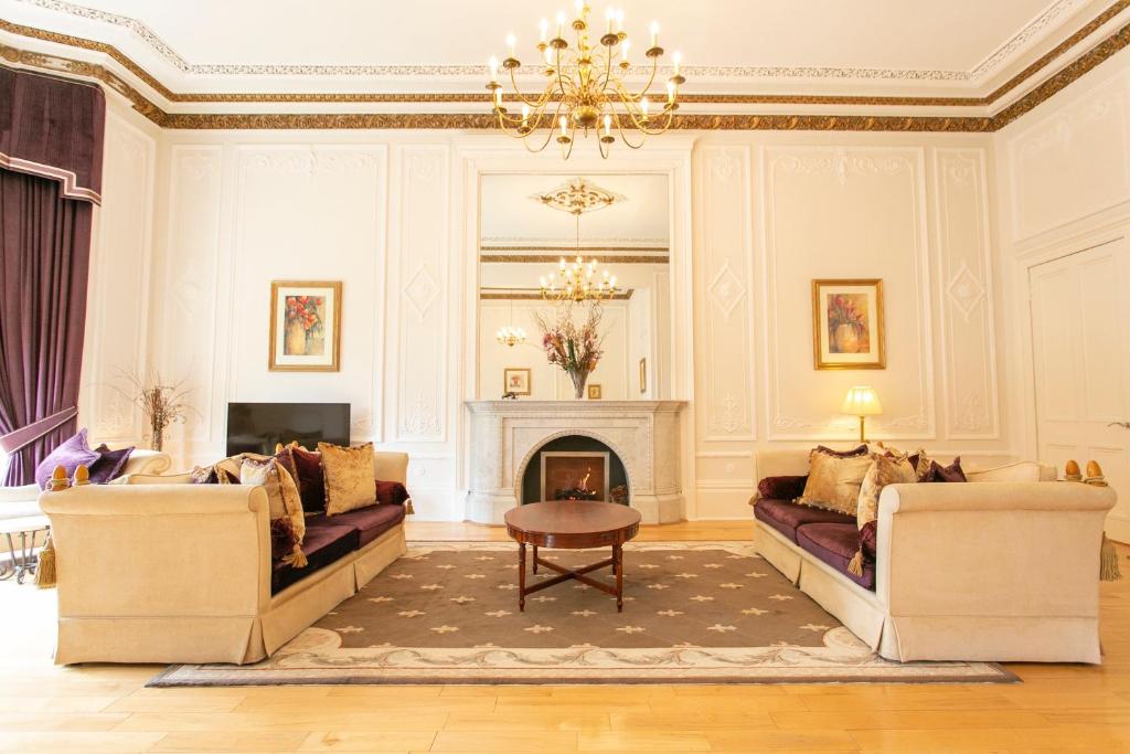 格拉斯哥Grand in the Park的客厅设有两张沙发和一个壁炉