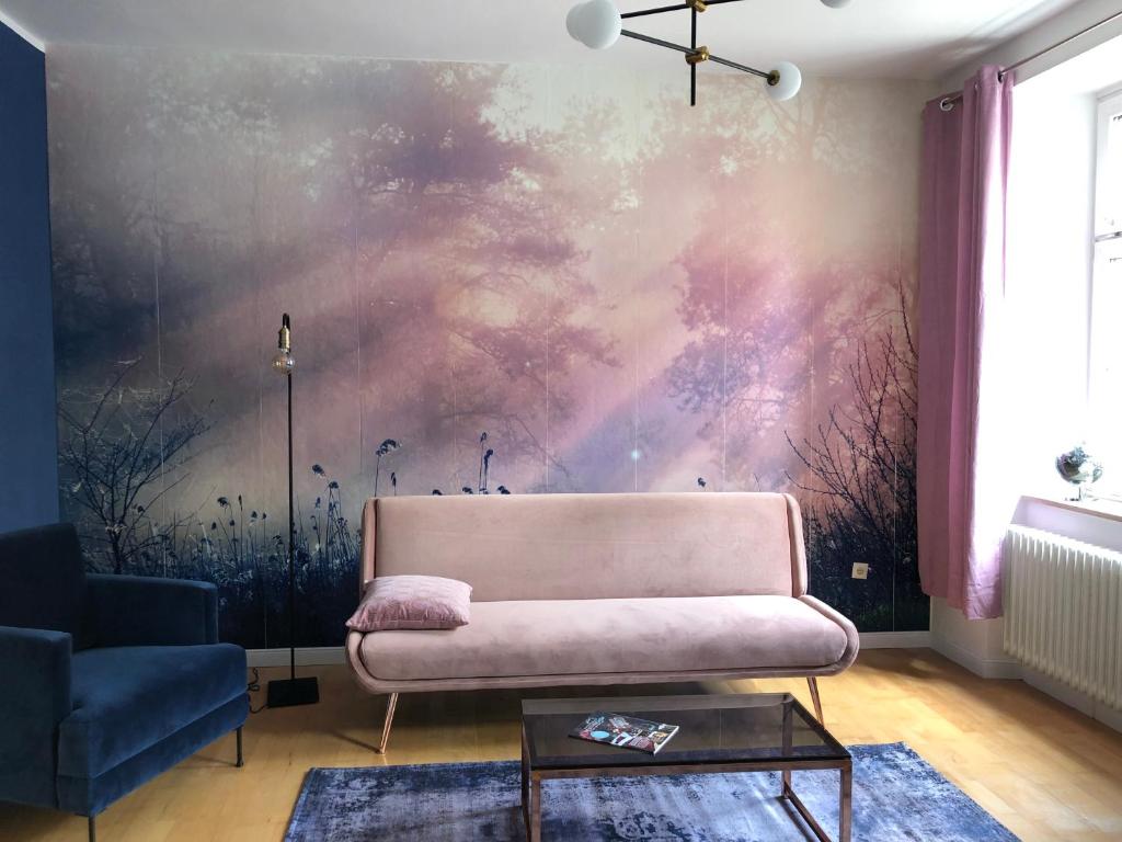 拜罗伊特Luna Estela的客厅配有粉红色的沙发和绘画