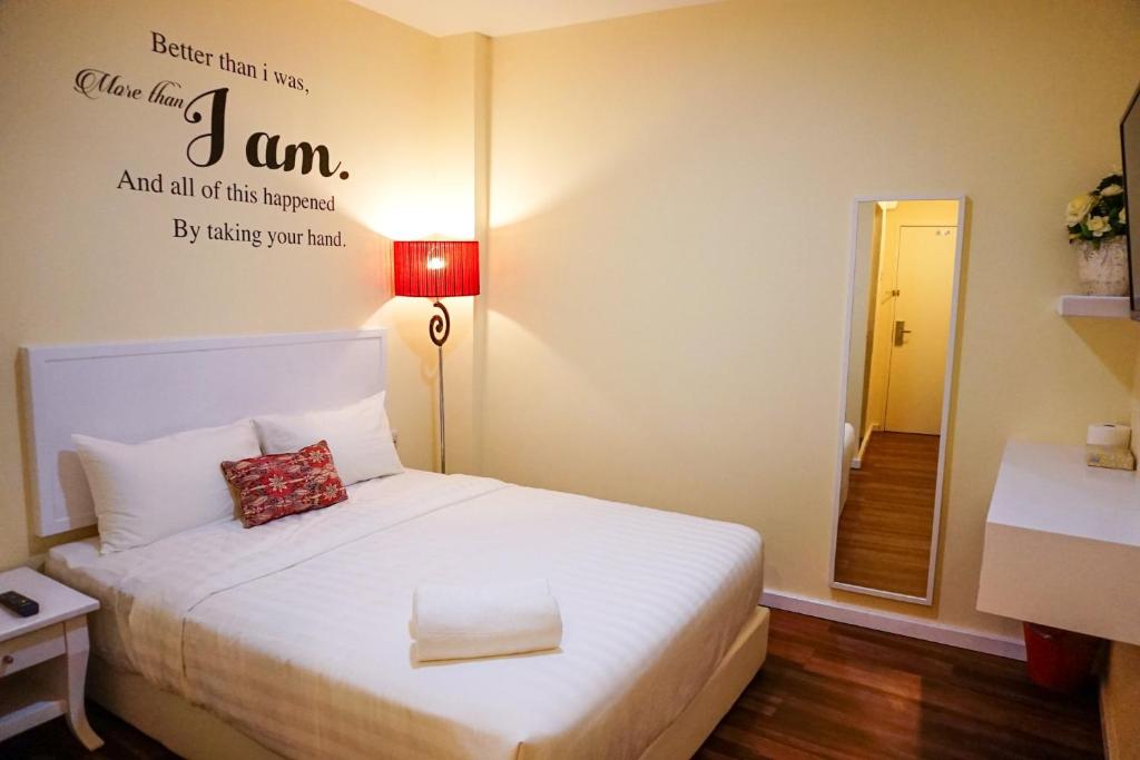 瓜拉丁加奴TY Hotel的卧室配有白色的床铺和白色的枕头