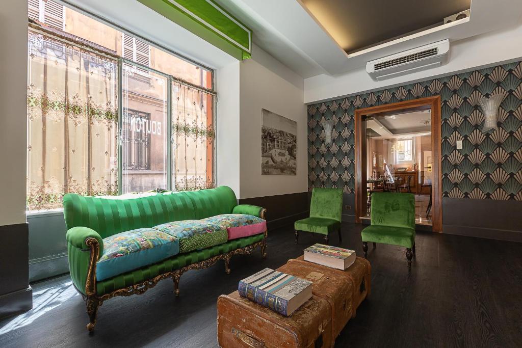 帕尔马布通酒店的客厅配有绿色沙发和2把绿色椅子