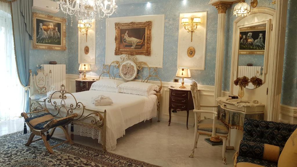 切里尼奥拉Luxury B&B IL Sogno的一间卧室配有一张床、一张桌子和一把椅子
