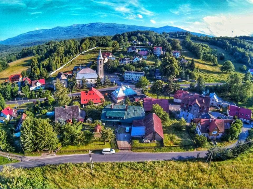 斯克拉斯卡波伦巴POKOJE GOŚCINNE JANINA ,Szklarska Poreba Dolna的享有山脉小村庄的空中景致