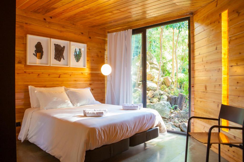 BiscoitosCaparica Azores Ecolodge的一间卧室设有一张床和一个大窗户