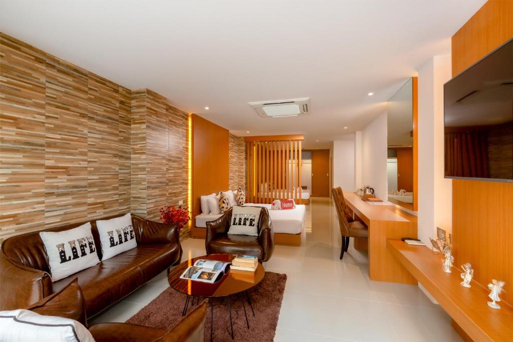 芭东海滩Club Bamboo Boutique Patong Beach Resort的客厅配有沙发和桌子