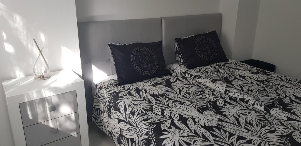 洛斯克里斯蒂亚诺斯Bubu Beach 2-B的一张带黑白毯子和枕头的床