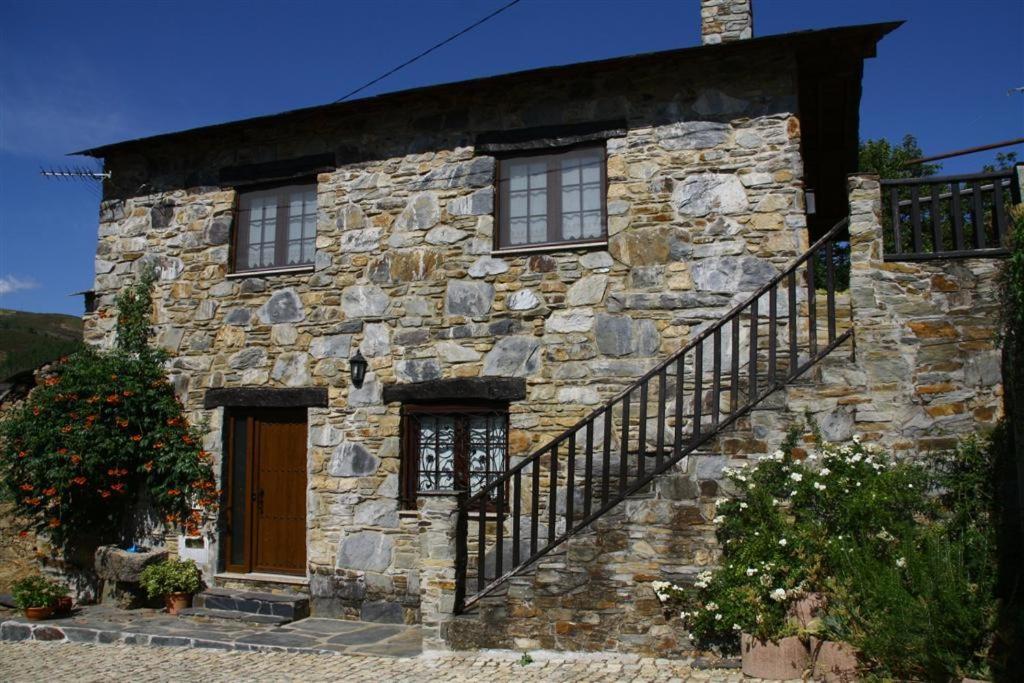 布拉干萨Ninho do Melro - Turismo Rural Bragança的石头房子的一侧有楼梯