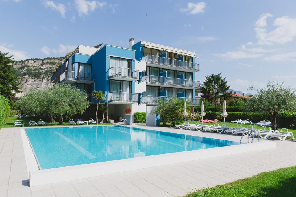 托尔博莱Hotel Holiday Sport & Relax的一座别墅,在一座建筑前设有一个游泳池