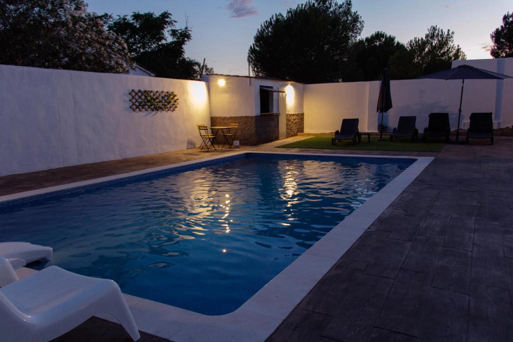 马尔帕尔蒂达德卡塞雷斯La Berruca Casa Rural Malpartida de Cáceres的一座房子后院的游泳池