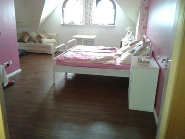 OstercappelnBoarding-Haus, Ostercappeln的卧室配有粉红色的床和沙发