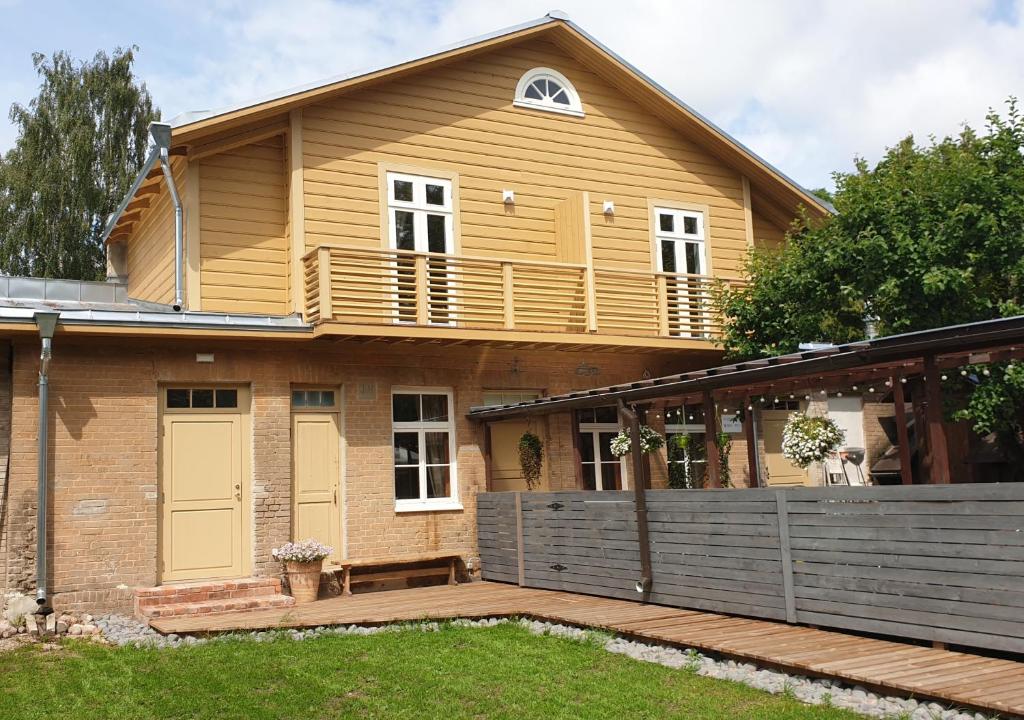 沃鲁Taevas Külalistemaja的房屋设有木制甲板和阳台