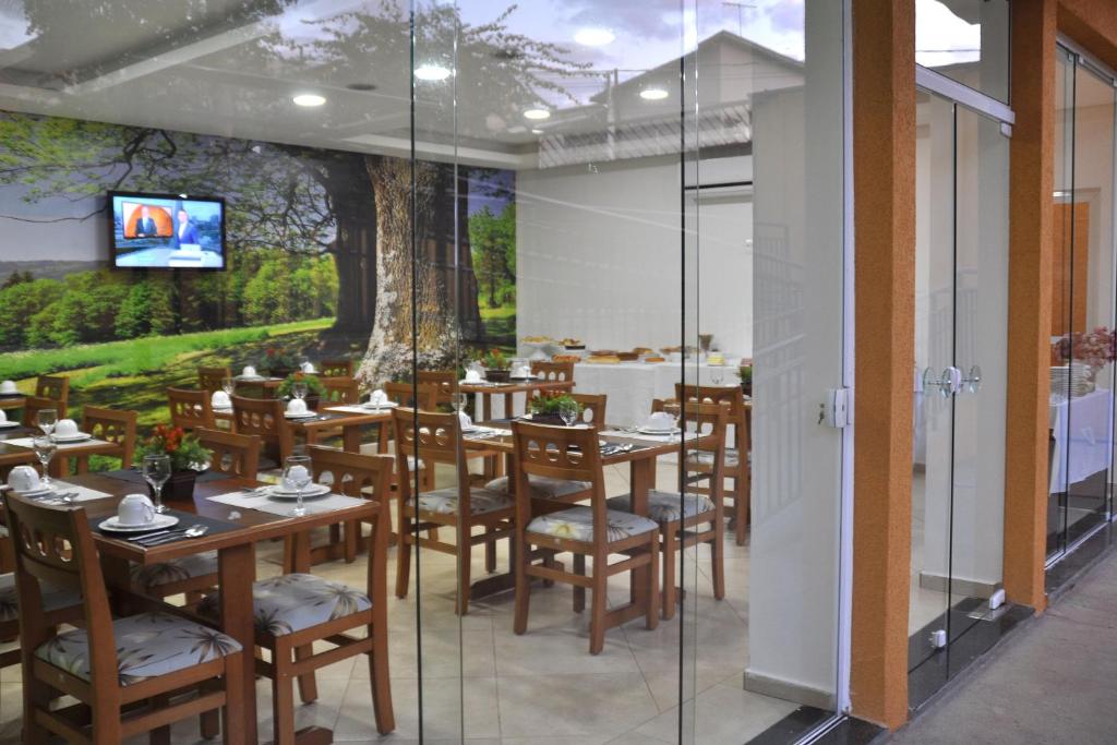 里贝朗普雷托香格里拉旅馆的一间带木桌椅的餐厅以及壁画
