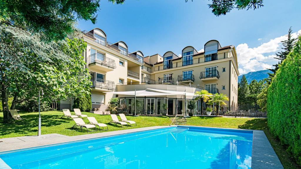 梅拉诺Hotel Villa Laurus的享有带游泳池的大厦外部景色