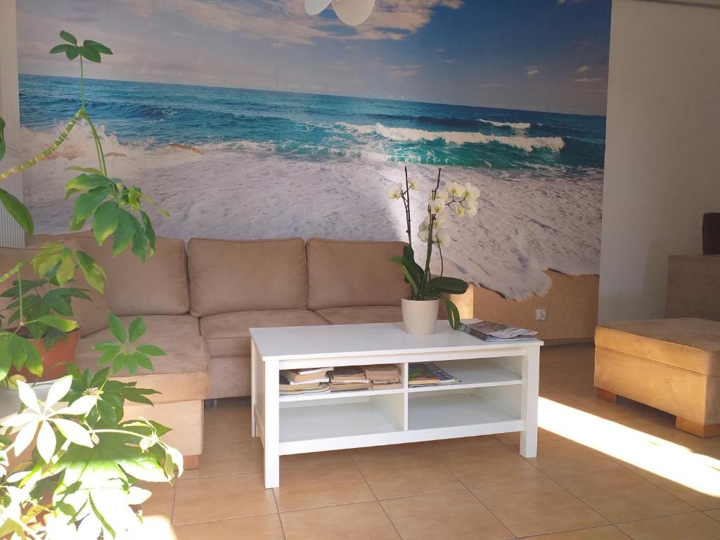 米兹多洛杰Bryza Międzyzdroje的客厅配有沙发和海滩绘画