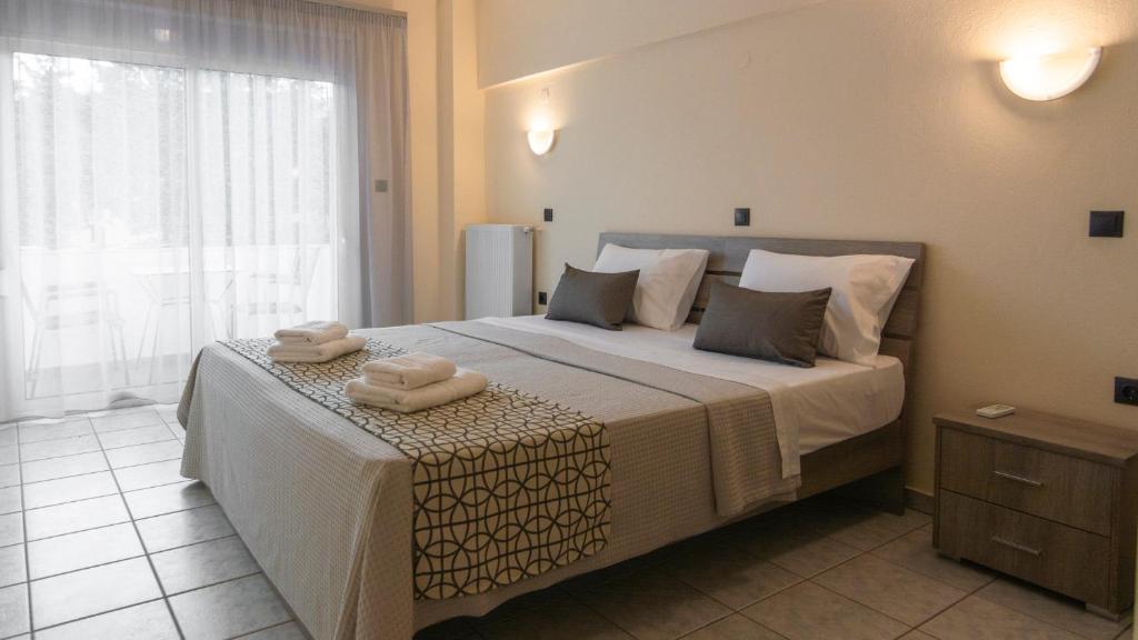 EleftheroúpolisPravi Hotel的一间卧室配有一张大床和两条毛巾