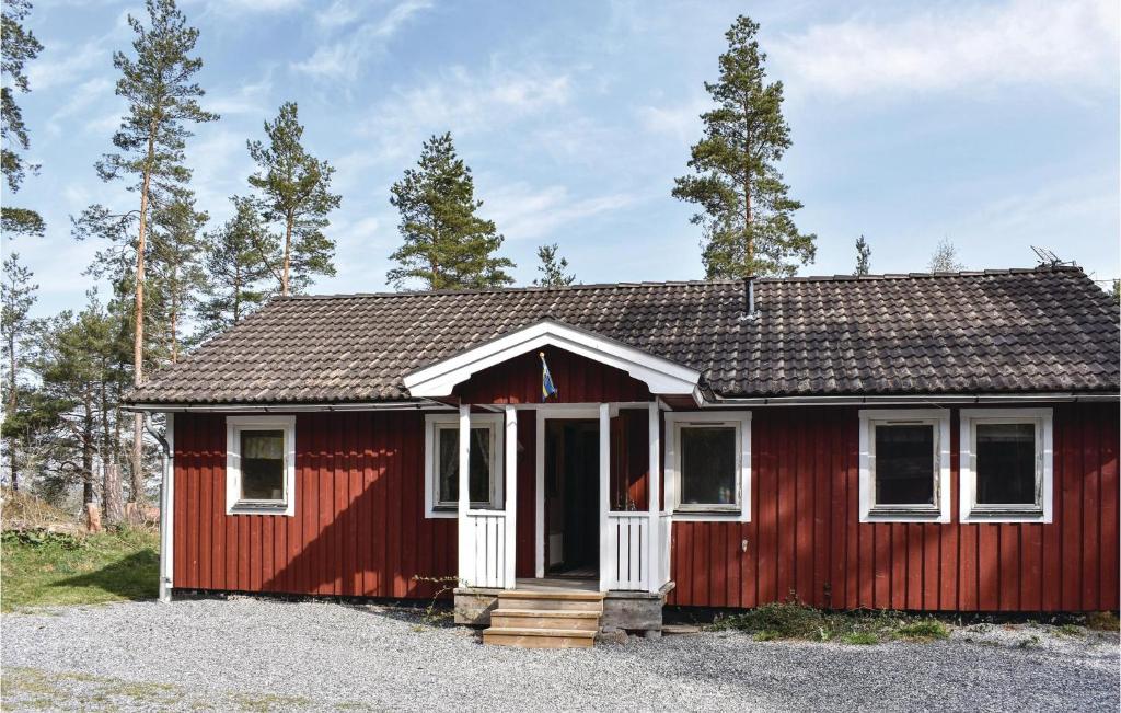 瓦尔德马什维克Beautiful Home In Valdemarsvik With Kitchen的一间红色的小房子,有白色的门