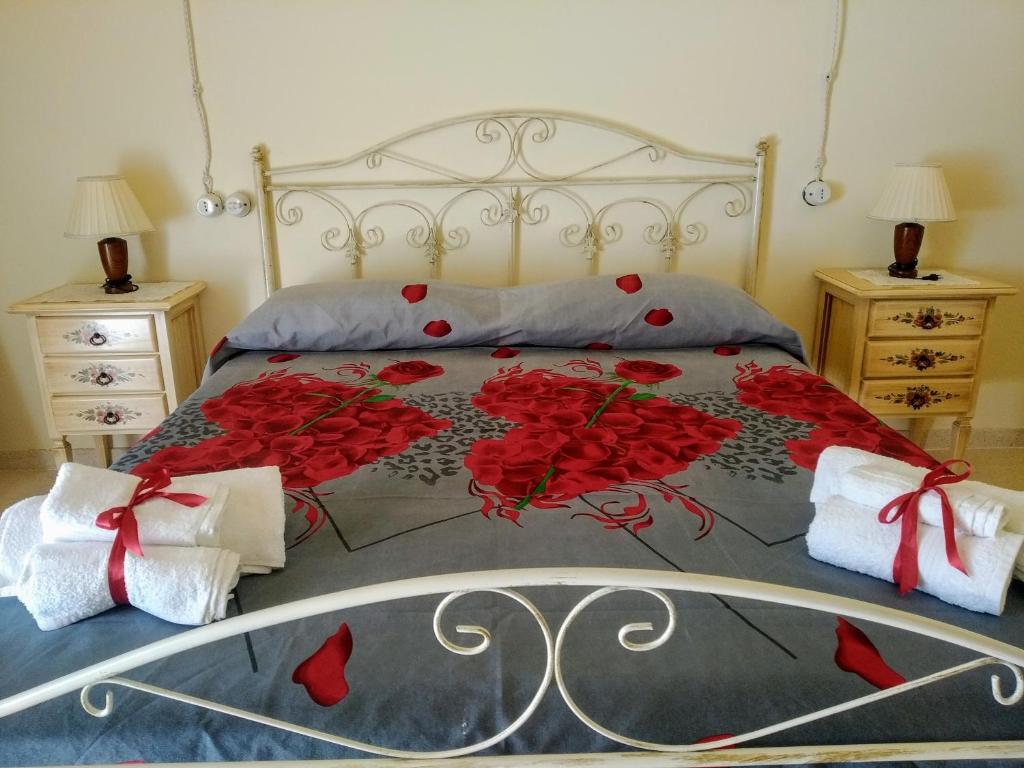 费尔莱恩Le Tre Volte a Stella Salentine的一间卧室,床上有红色玫瑰