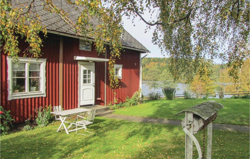 KorsbergaNice Home In Korsberga With Kitchen的院子里的红色房子,带野餐桌