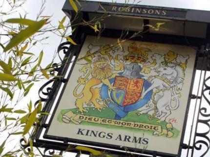 威姆斯洛The Kings Arms的挂在建筑物一侧的标志