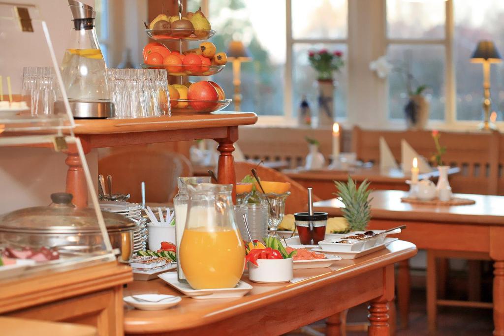 阿伦斯霍普兰德苏西温德度假屋的餐桌,带食物和橙汁盘