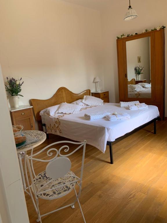 VillalfonsinaLa stanza di Caterina的一间卧室配有一张床、镜子和椅子