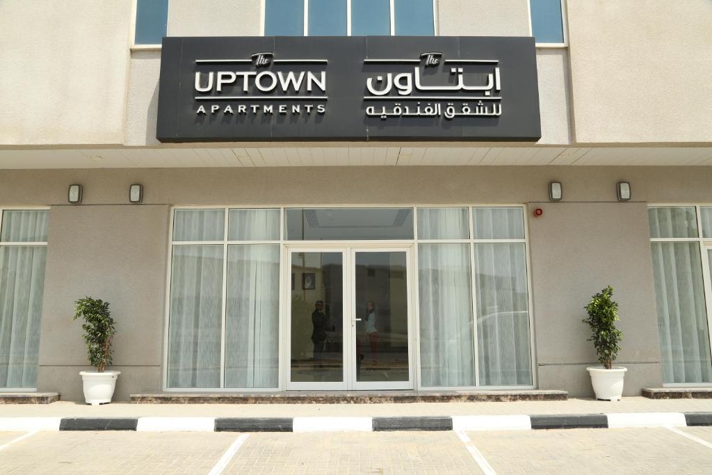富查伊拉Uptown Hotel Apartment Fujairah By Gewan的带有上城公寓读号的建筑