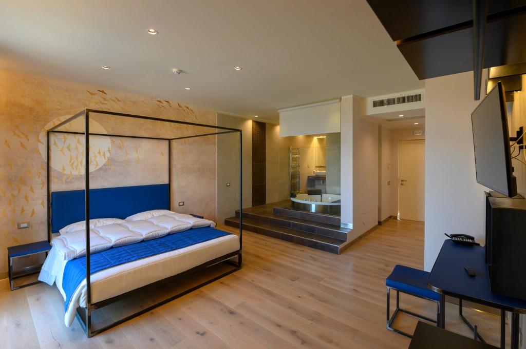 蒙蒂菲阿斯科尼拉卡罗扎多罗酒店的一间卧室配有一张带玻璃天篷的床