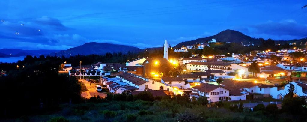 瓜塔维塔Living Club的一座晚上点燃的小镇,背景是群山