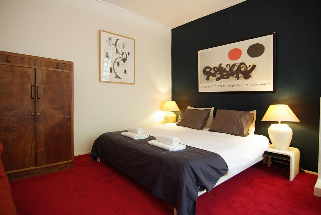 阿姆斯特丹Wooden Mill B&B的一间卧室配有一张大床和一个橱柜