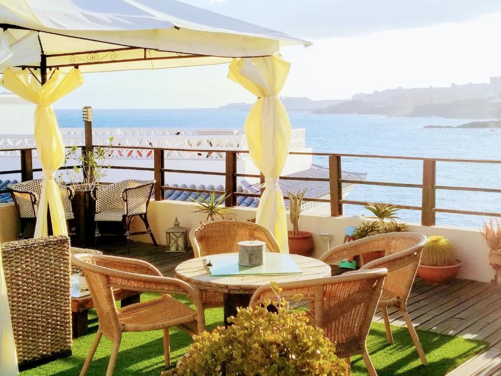 阿布里斯Estrella del Mar的一个带桌椅的庭院和大海