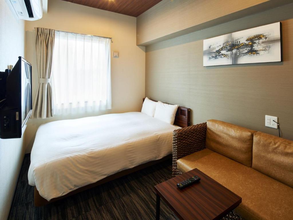 One's Hotel Fukuoka客房内的一张或多张床位