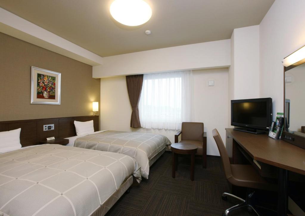 半田半田龟崎茹特酒店的酒店客房配有两张床和一张书桌